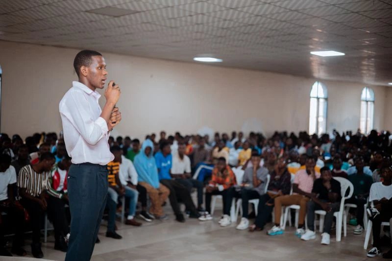 Speaking to a hall full of students